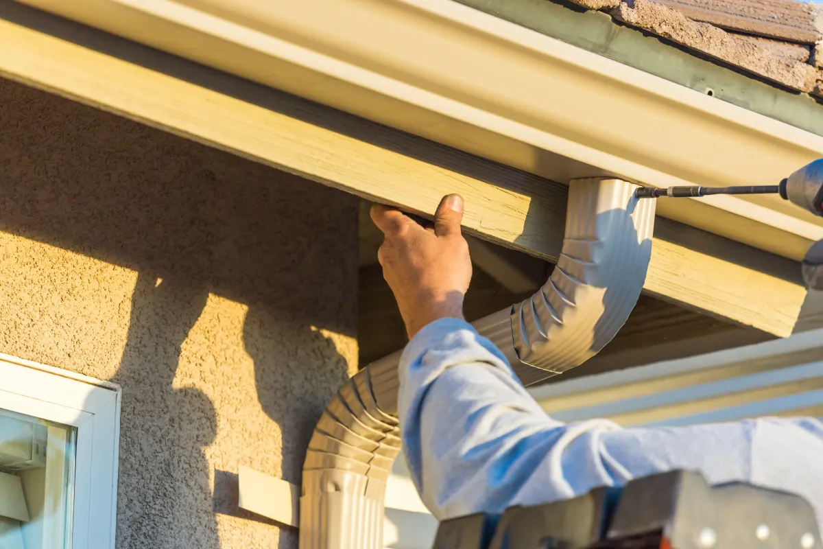 Team Member Repairing the Aluminum Down Spout of a House in Albany GA