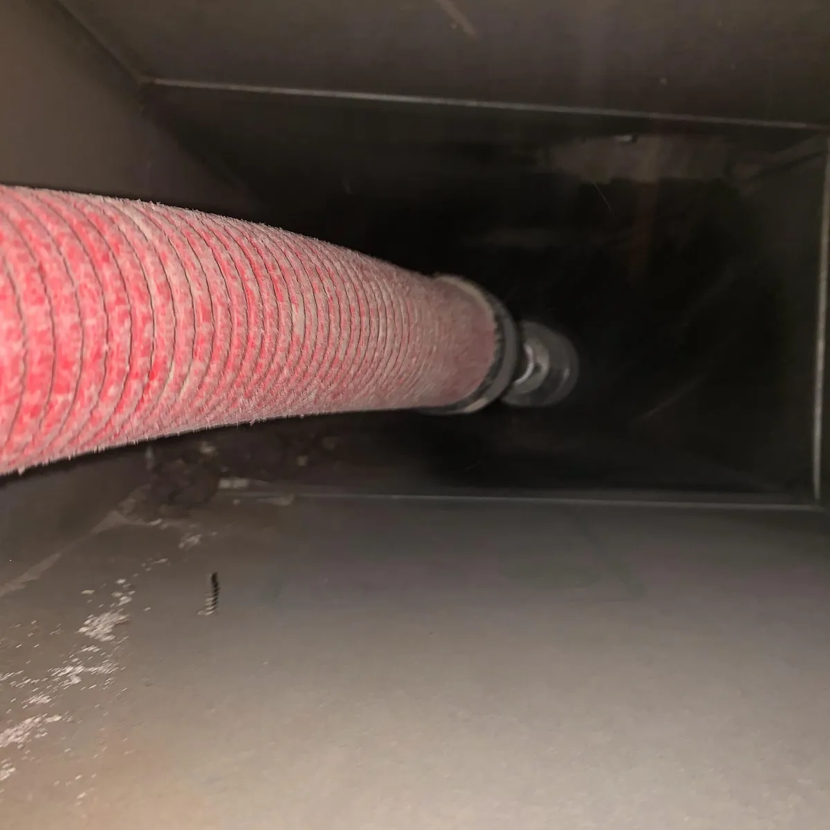 vacuuming an air duct vent