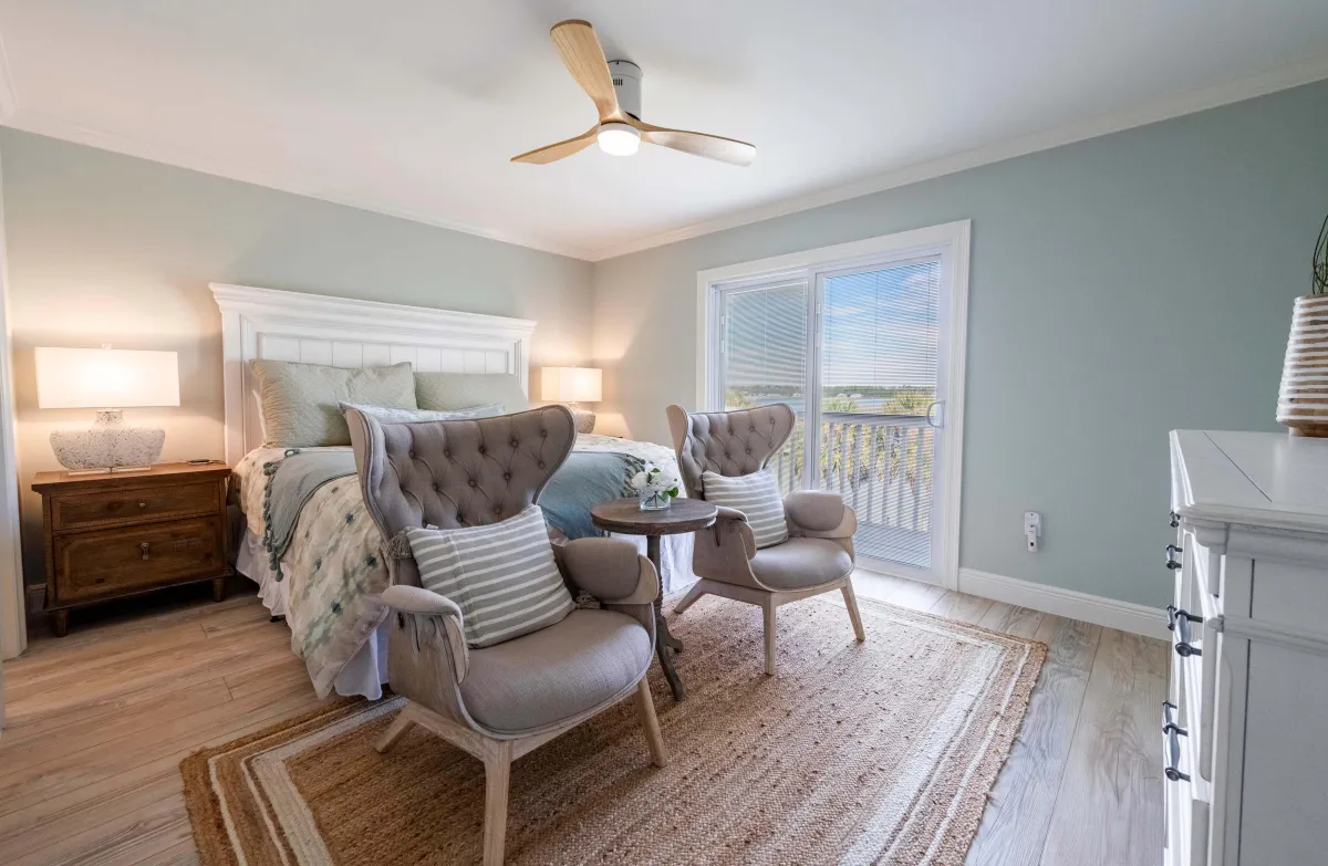 Modern bedroom with large bed, elegant decor, and sophisticated wall artwork.