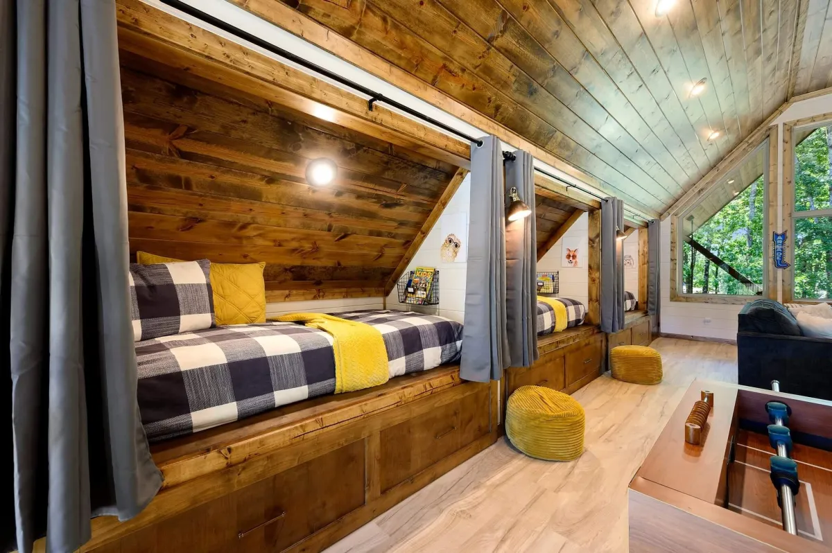 Rustic bedroom with bunk beds, wood ceiling, modern accents, and serene vibes.