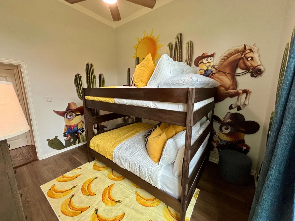 Charming loft bedroom with wooden ceilings, cozy beds, and rustic decor.