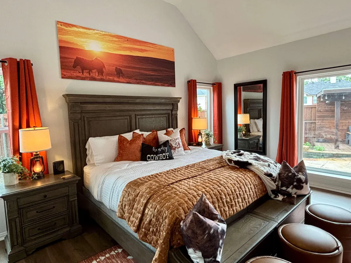 Inviting bedroom with large windows, plush bedding, and peaceful forest views.