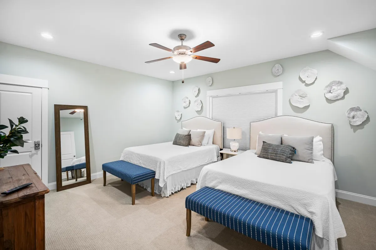 Rustic bedroom with bunk beds, wood ceiling, modern accents, and serene vibes.