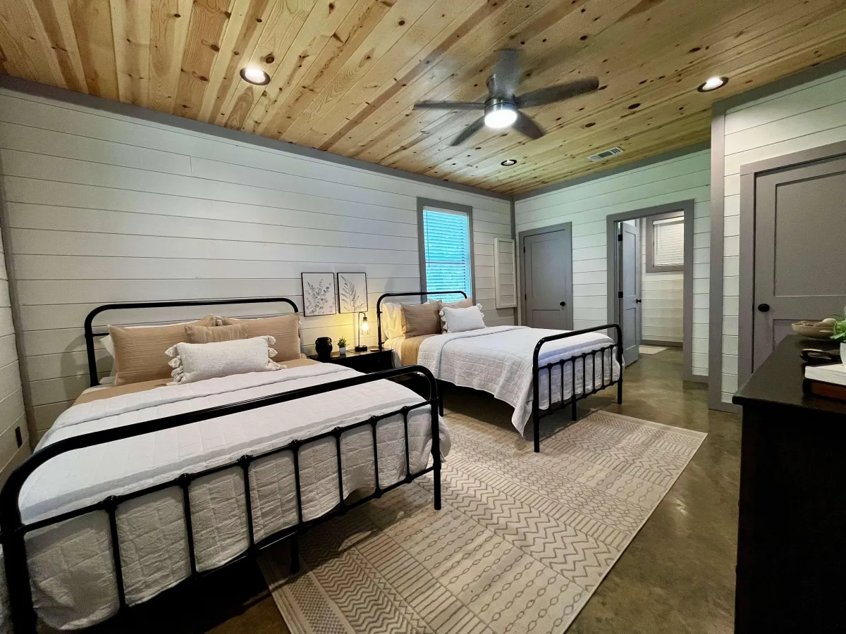 Rustic bedroom with wood accents, modern decor, and ample natural light.