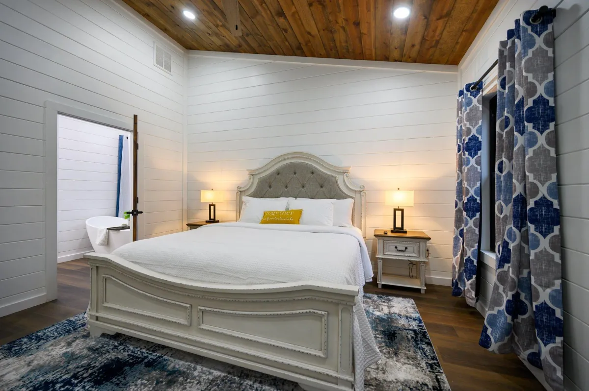 Rustic bedroom with bunk beds, wood ceiling, modern accents, and serene vibes.