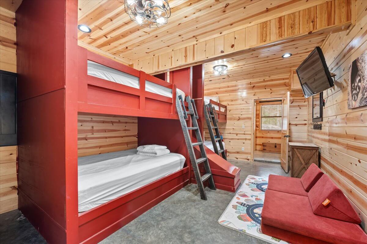 Inviting bedroom with large windows, plush bedding, and peaceful forest views.