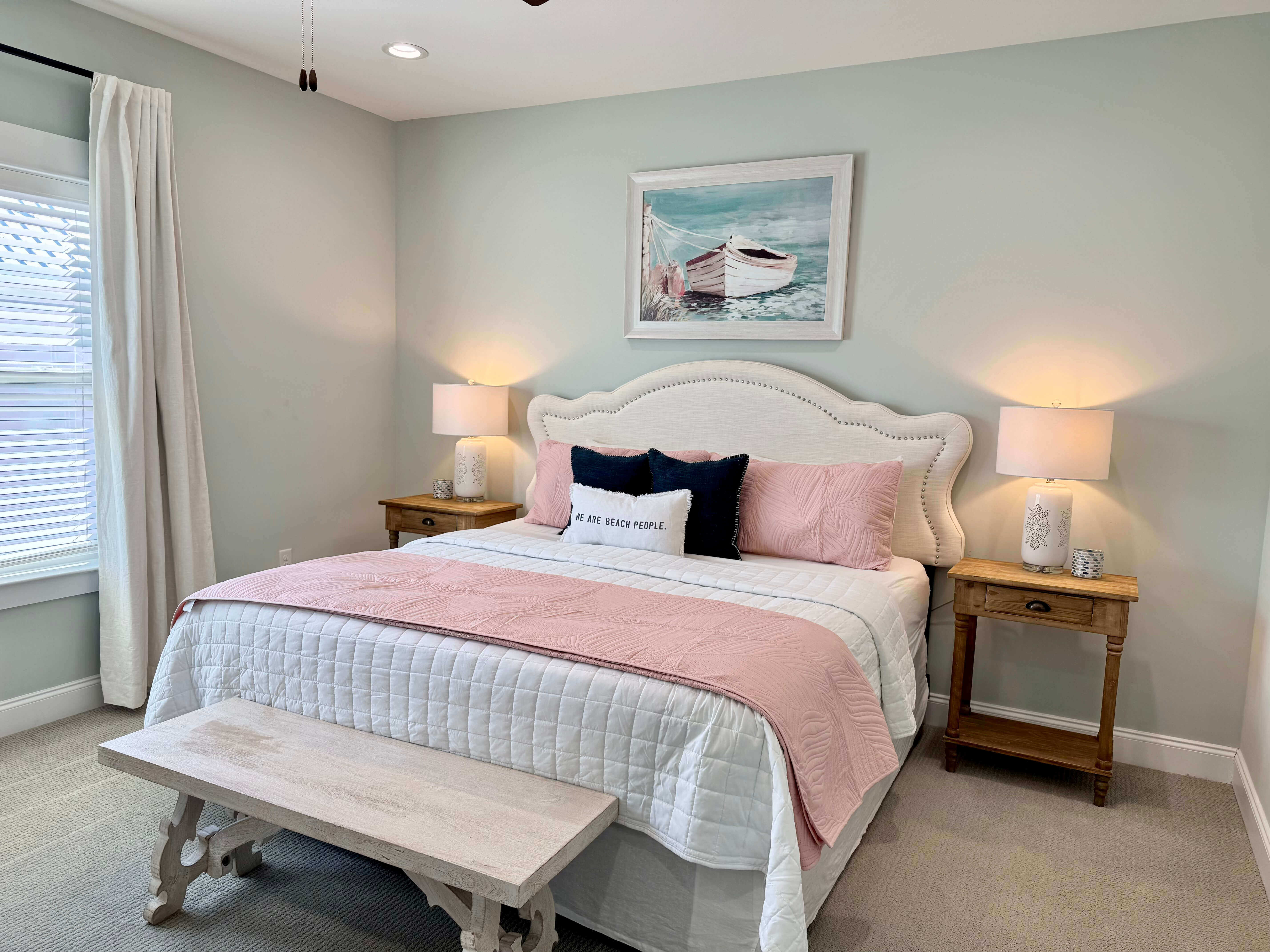 Inviting bedroom with large windows, plush bedding, and peaceful forest views.