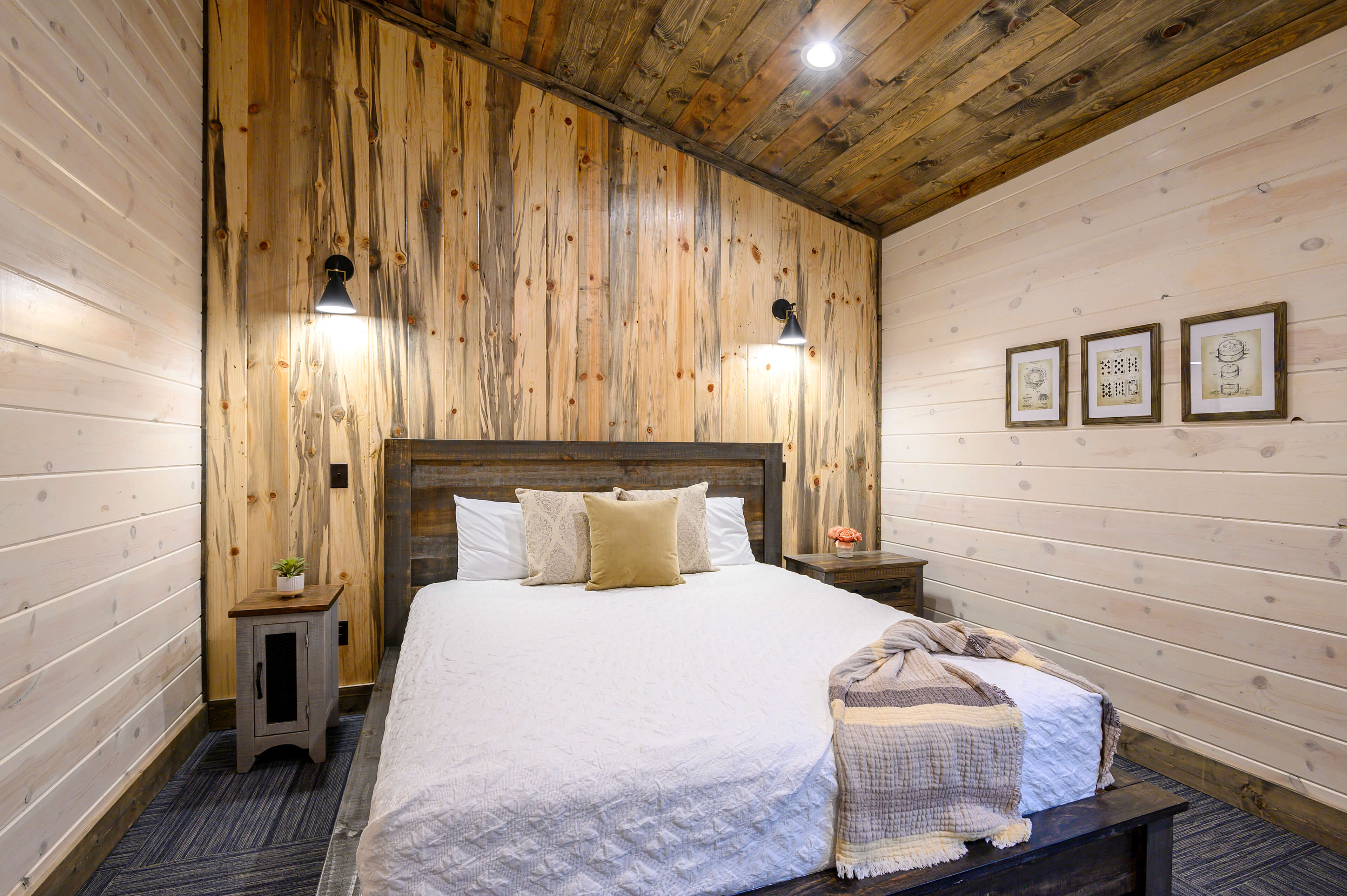 Rustic bedroom with bunk beds, wood ceiling, modern accents, and serene vibes.