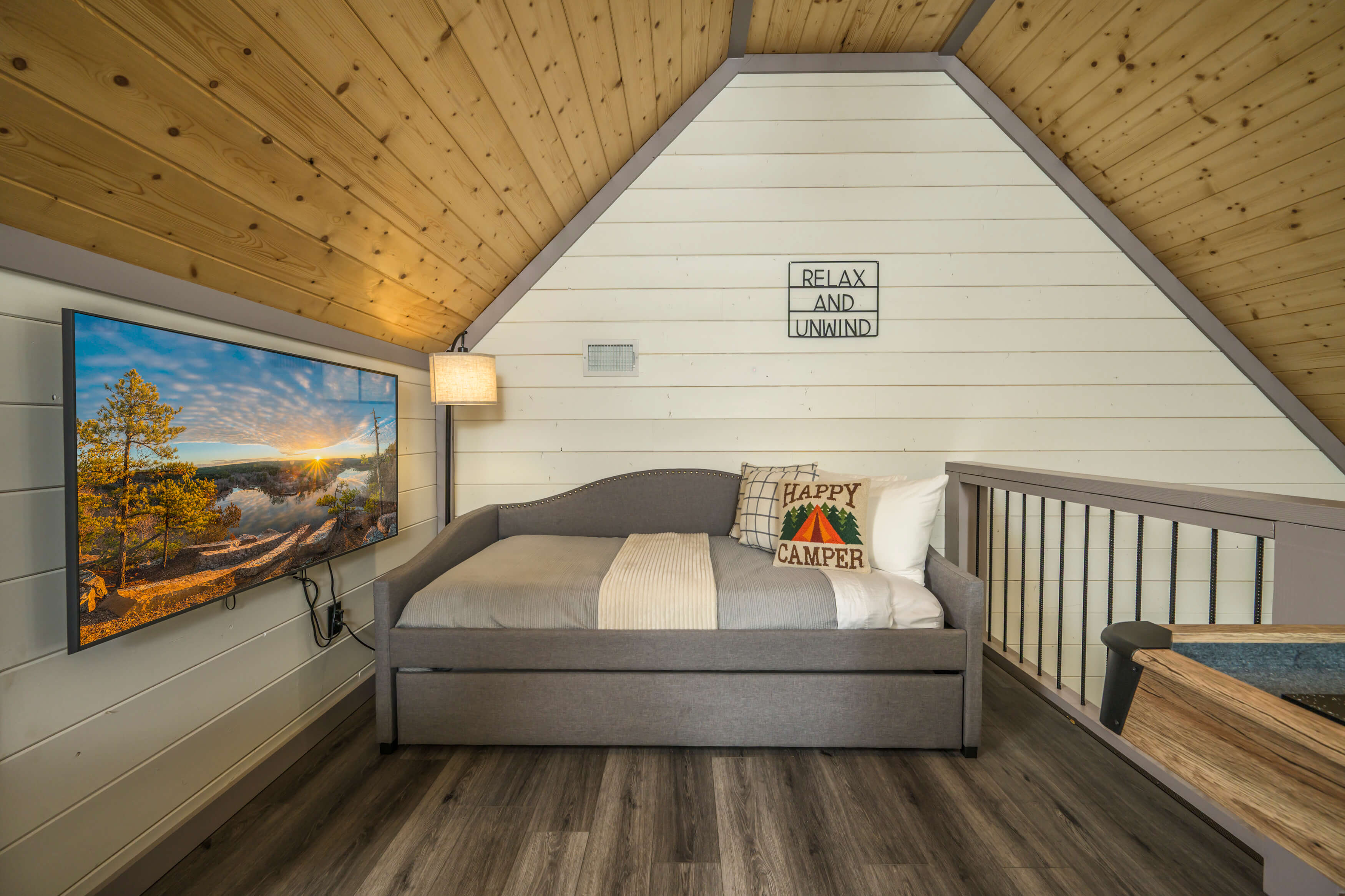 Rustic bedroom with wood accents, modern decor, and ample natural light.