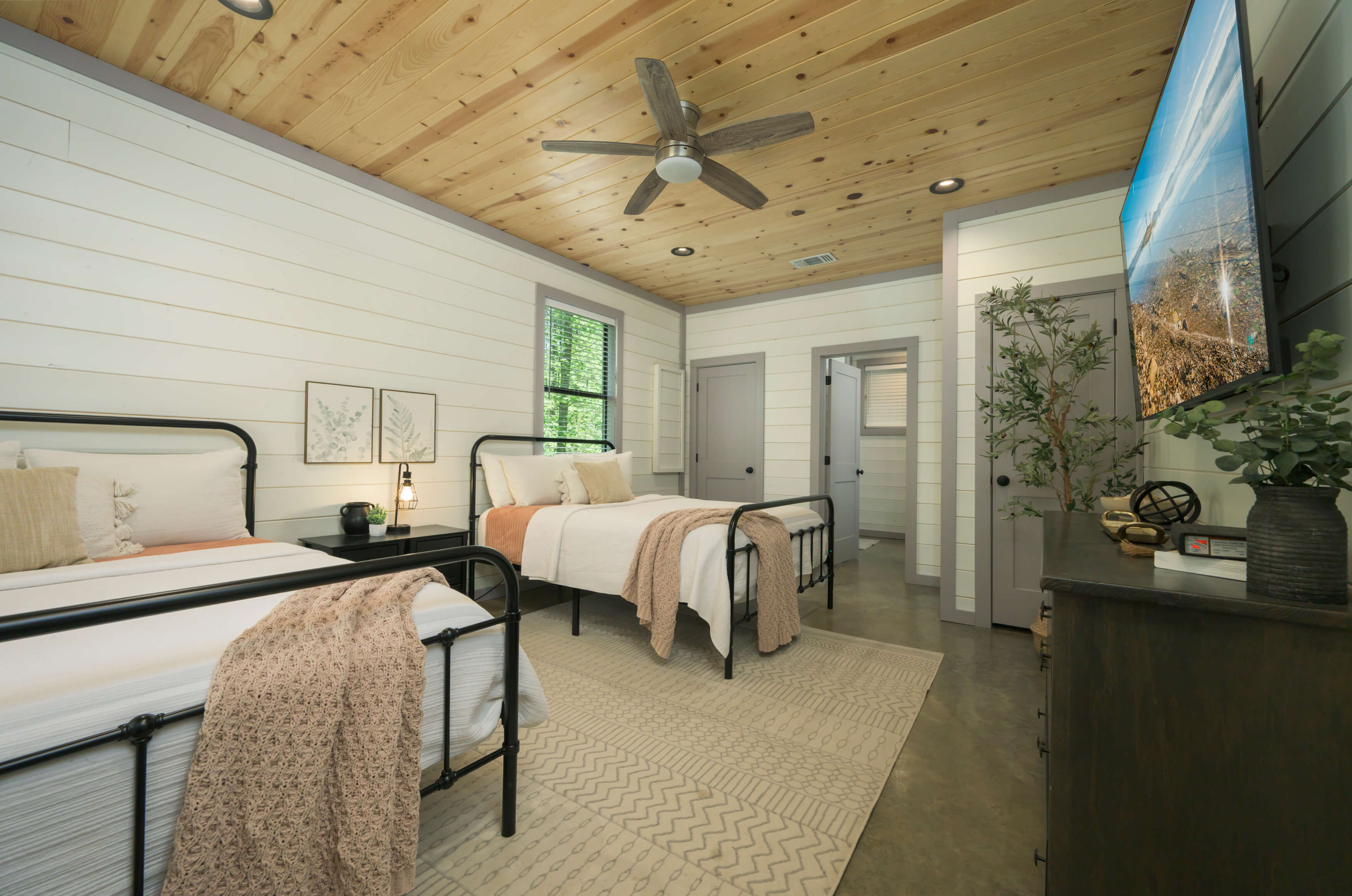Rustic bedroom with wood accents, modern decor, and ample natural light.