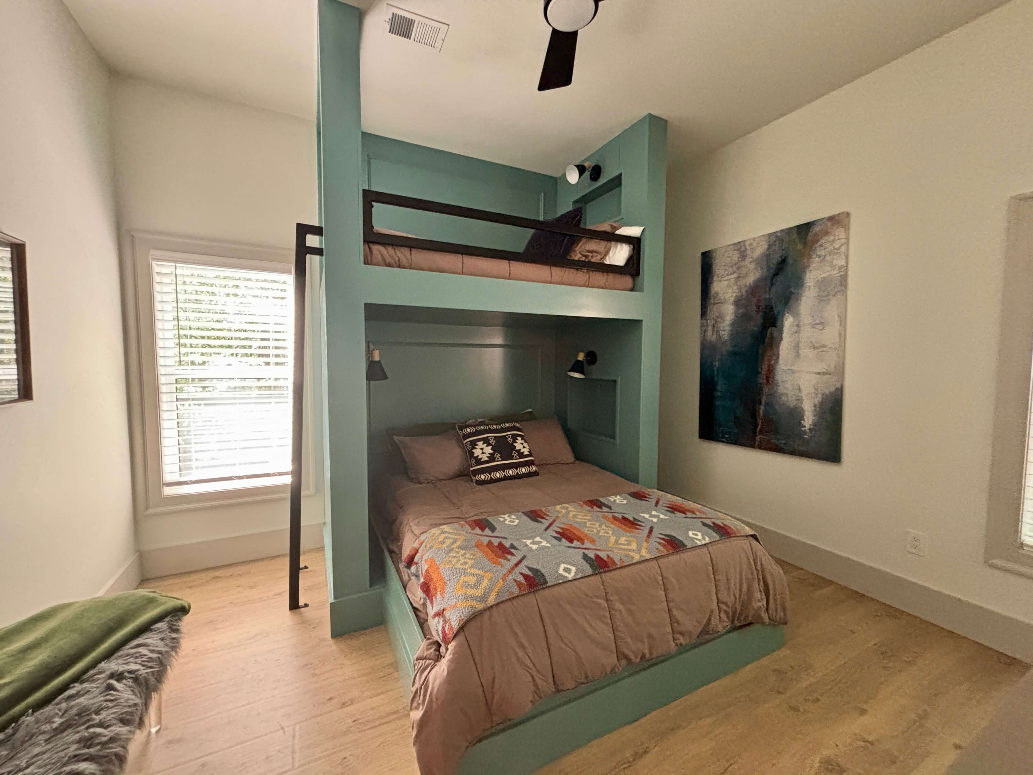 Rustic bedroom with bunk beds, wood ceiling, modern accents, and serene vibes.