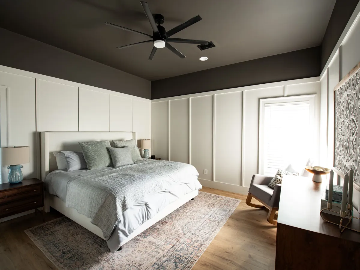 Inviting bedroom with large windows, plush bedding, and peaceful forest views.