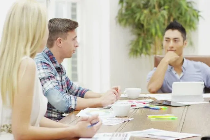 people raising hands with bokeh lights