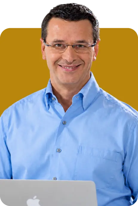 Portrait of Phil Symchych in a suit and glasses against a solid yellow background