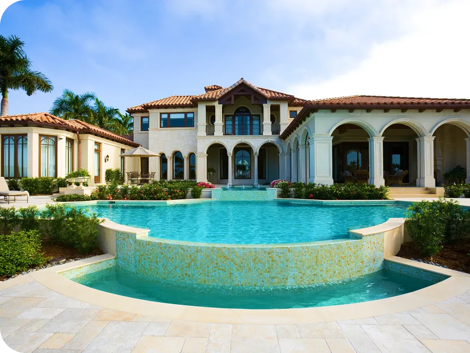 Elegant Mediterranean-style mansion with a luxury infinity pool and arched columns.