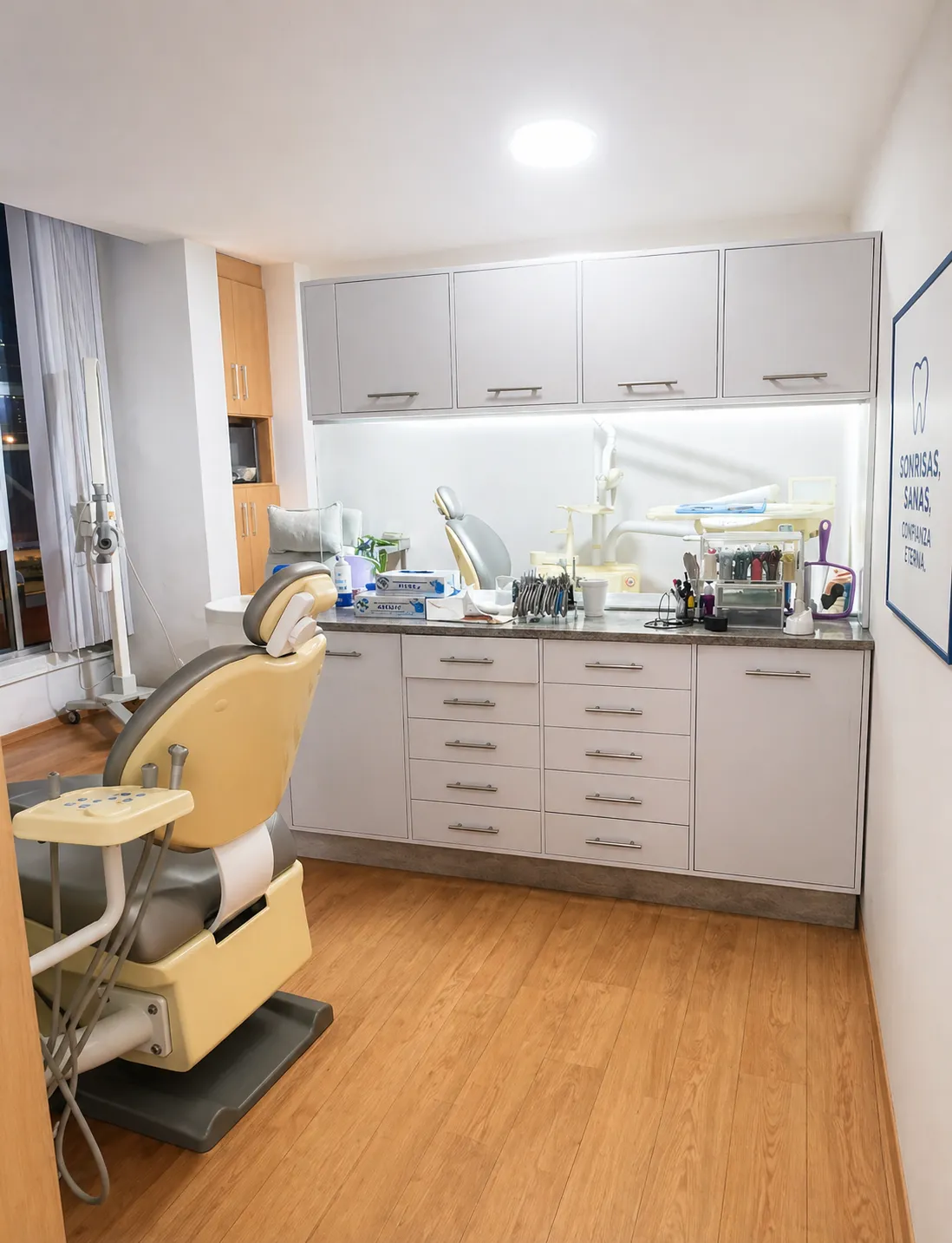 a dental room with a chair and a monitor