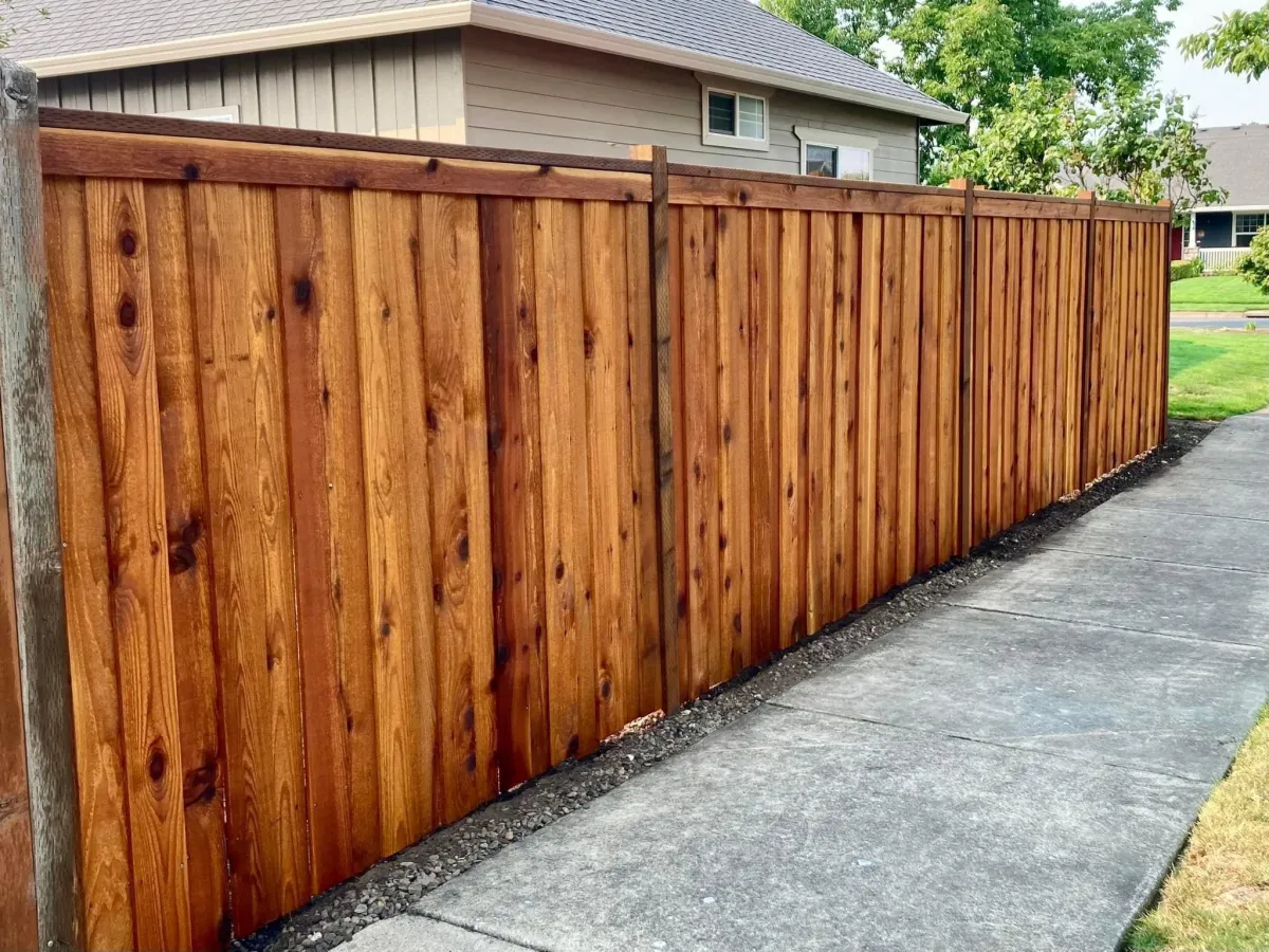 Custom-built wooden privacy fence installed along residential property line for durability and security