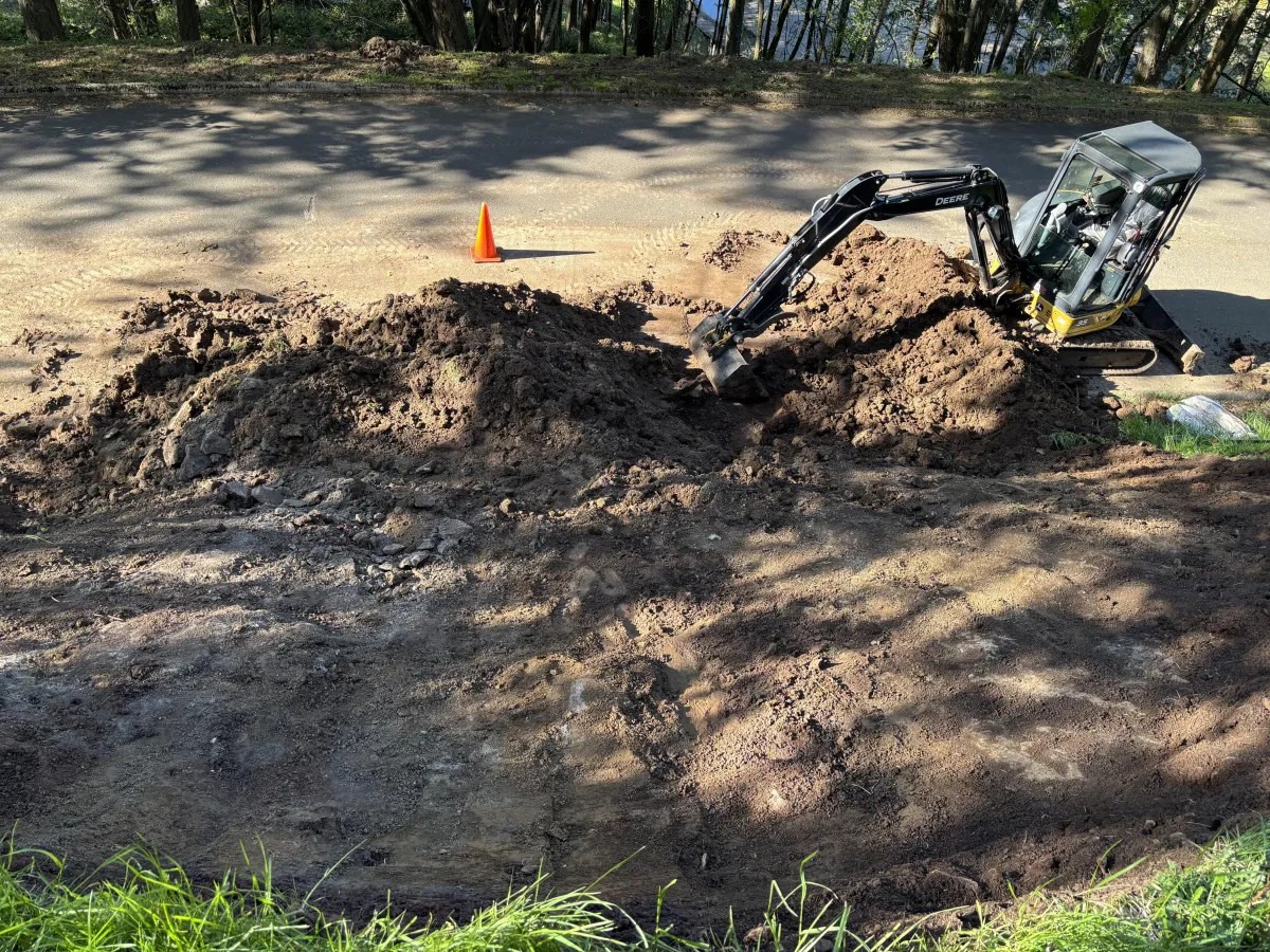 Emergency landslide cleanup using excavator to remove unstable soil in South Eugene Hills, Oregon