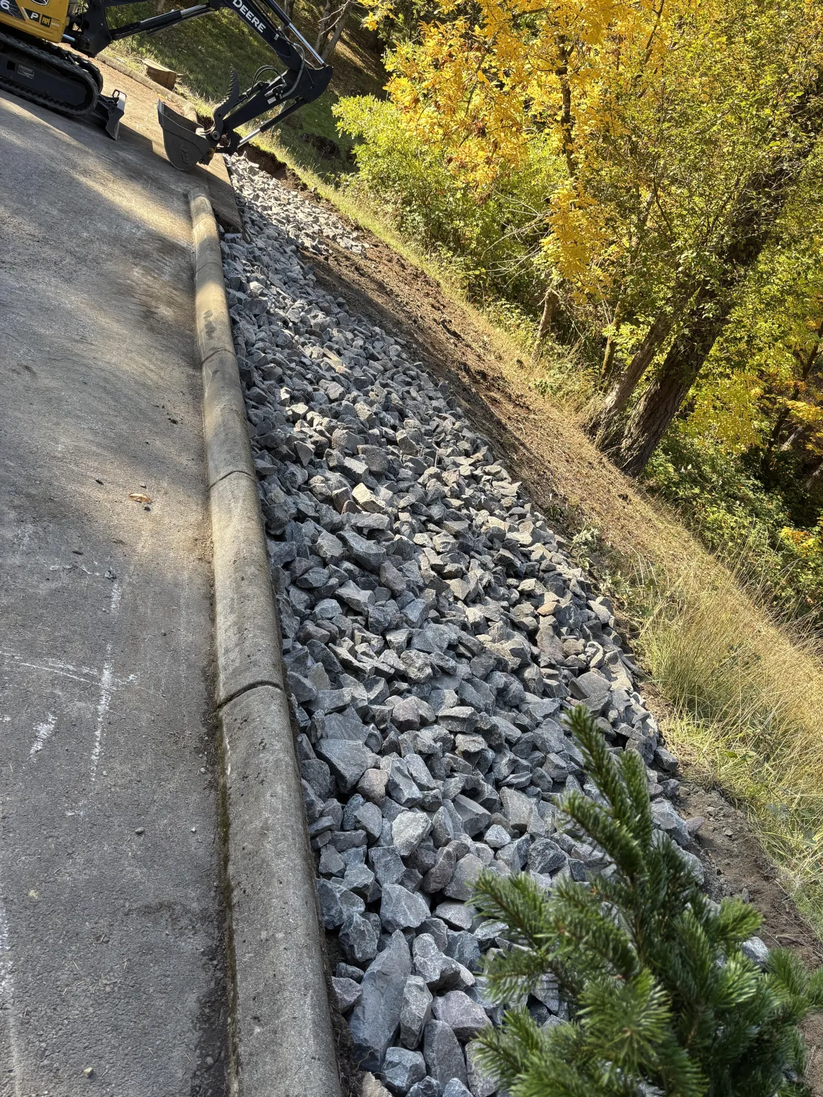 Completed landslide mitigation with gravel erosion control and stabilized slope along roadway in the South Eugene Hills, Oregon