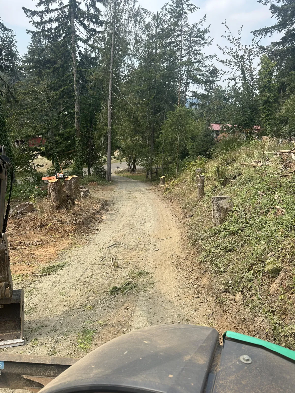 Excavator performing slope stabilization and hillside grading after landslide in South Eugene Hills, Oregon