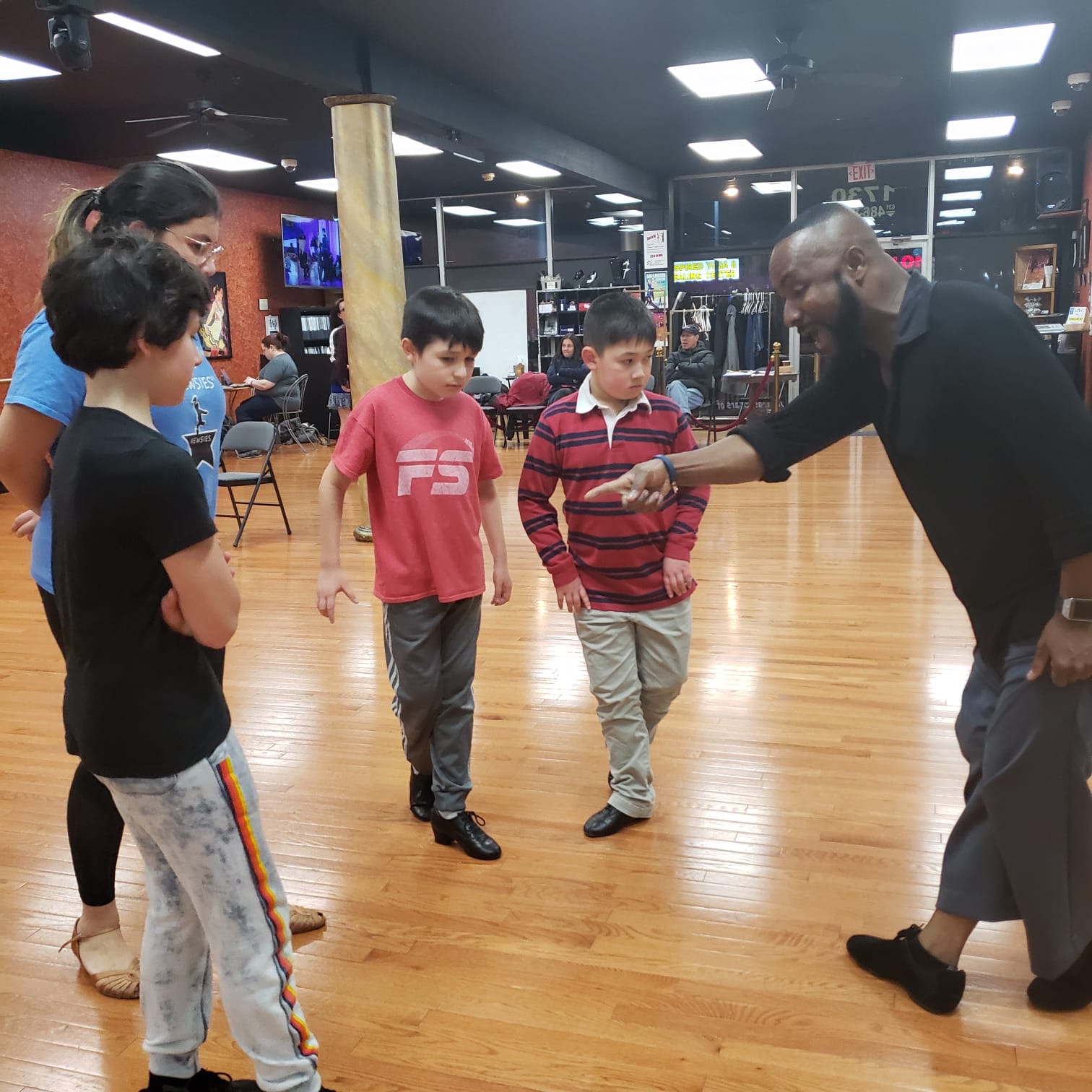 Kids ballroom dance group smiling and practicing