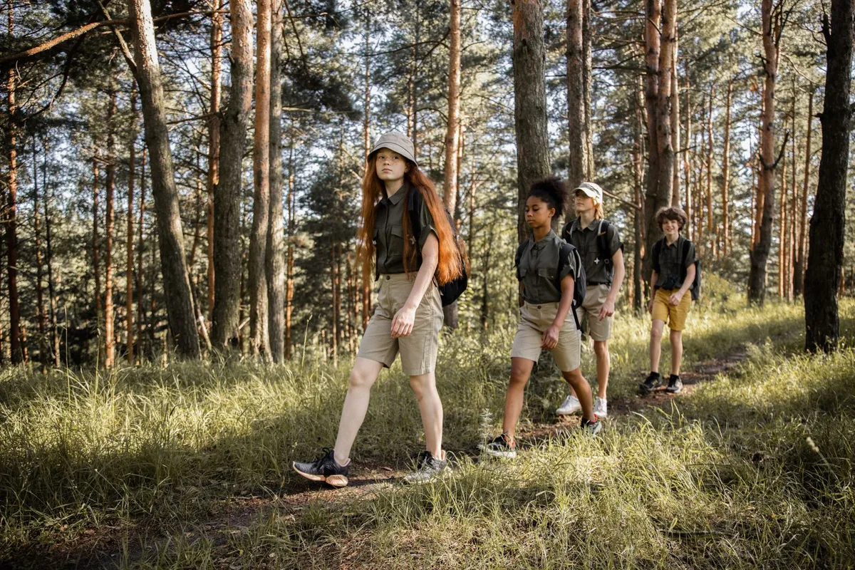 Teens hiking together on a forest trail