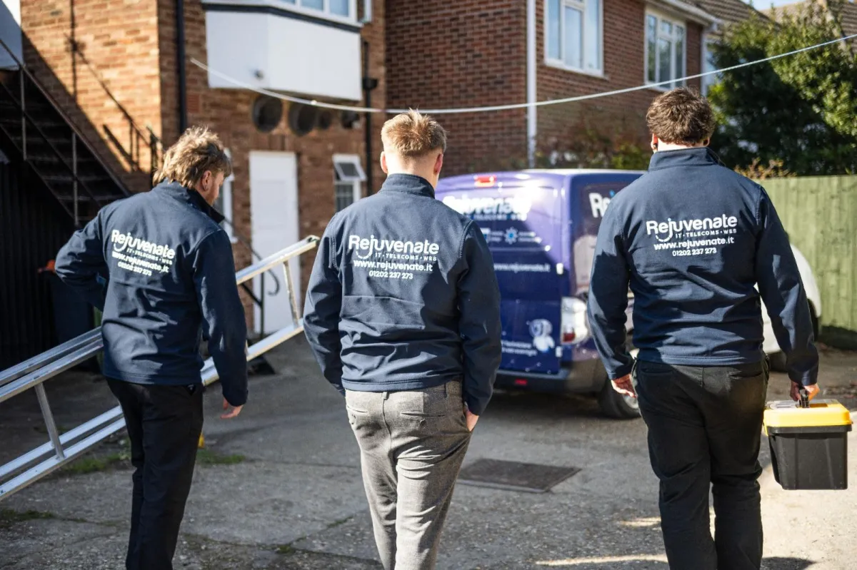 Custom hoodies with logos being worn by a work team.