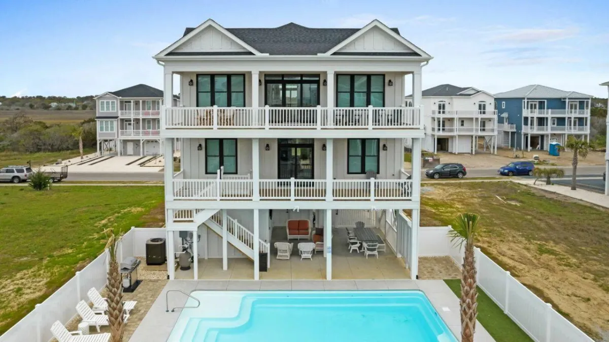 Three-story beachfront property with a private pool, exemplifying high-end real estate investments managed by Rise Capital Investments.