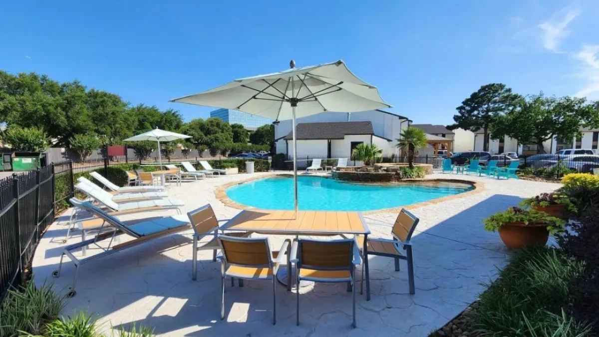 Spacious apartment pool and clubhouse managed by Rise Capital Investments, featuring resort-style amenities for residents.