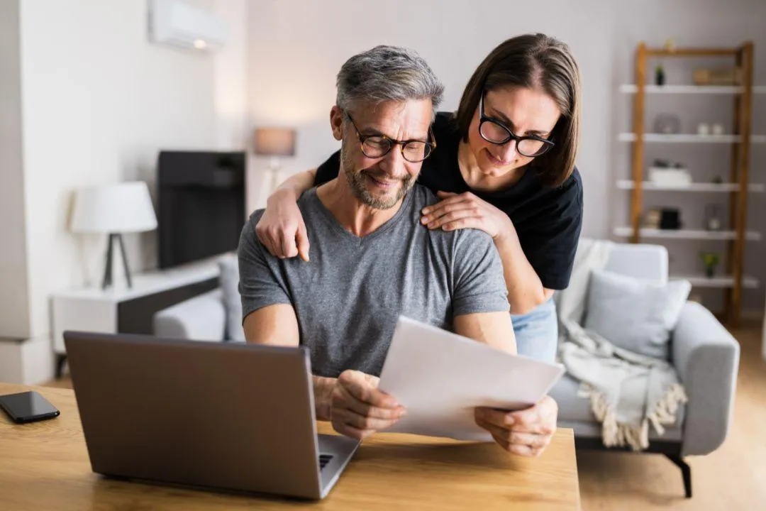 A middle age husband and wife looking at their finances 
