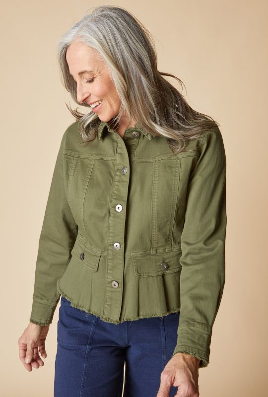 Woman wearing an olive green jacket and navy pants.