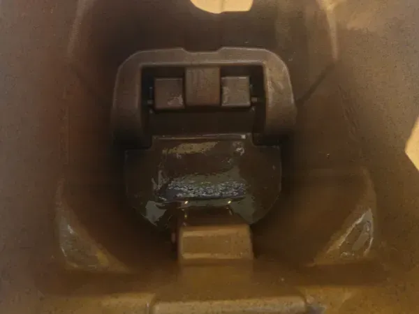 The inside of a dirty garbage bin with residue and grime before professional cleaning.