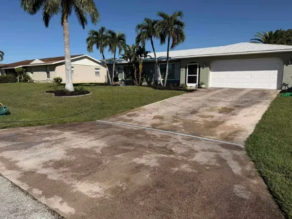 A stained and dirty sidewalk showing heavy grime before cleaning.