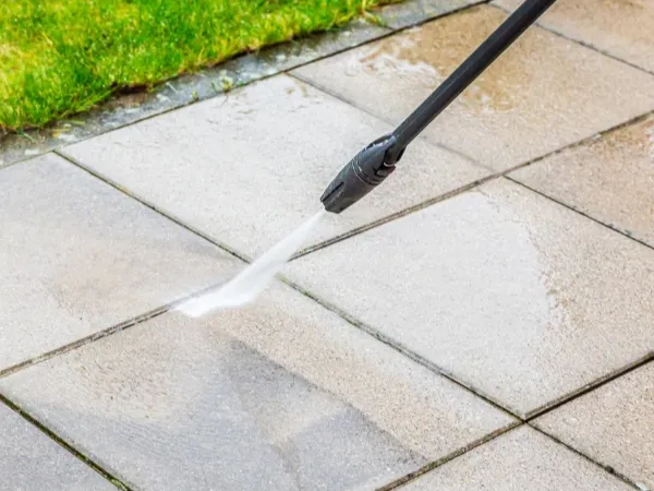 A stained and dirty sidewalk showing heavy grime before cleaning.