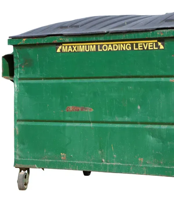 Green commercial dumpster with maximum loading level sign.