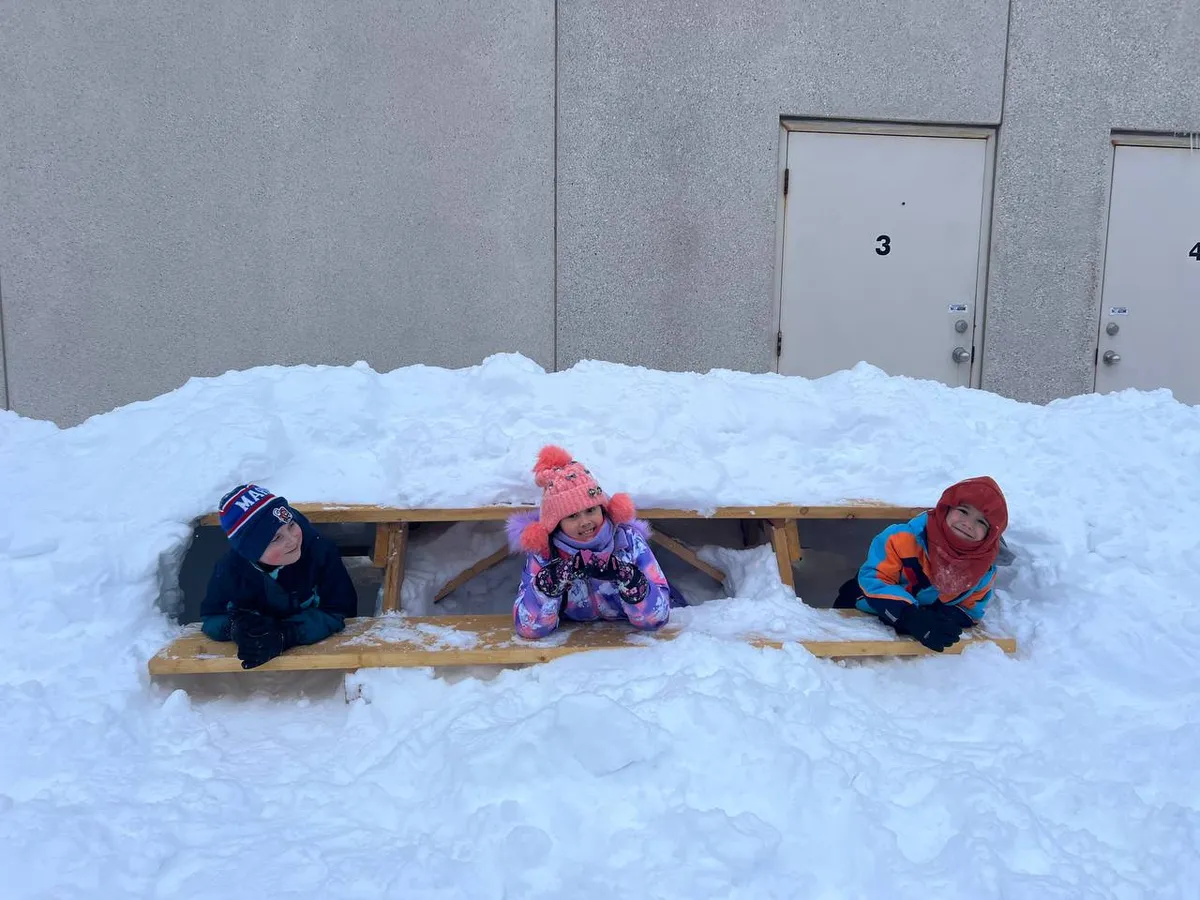 Evergreen children enjoying an outdoor activity in the snow.
