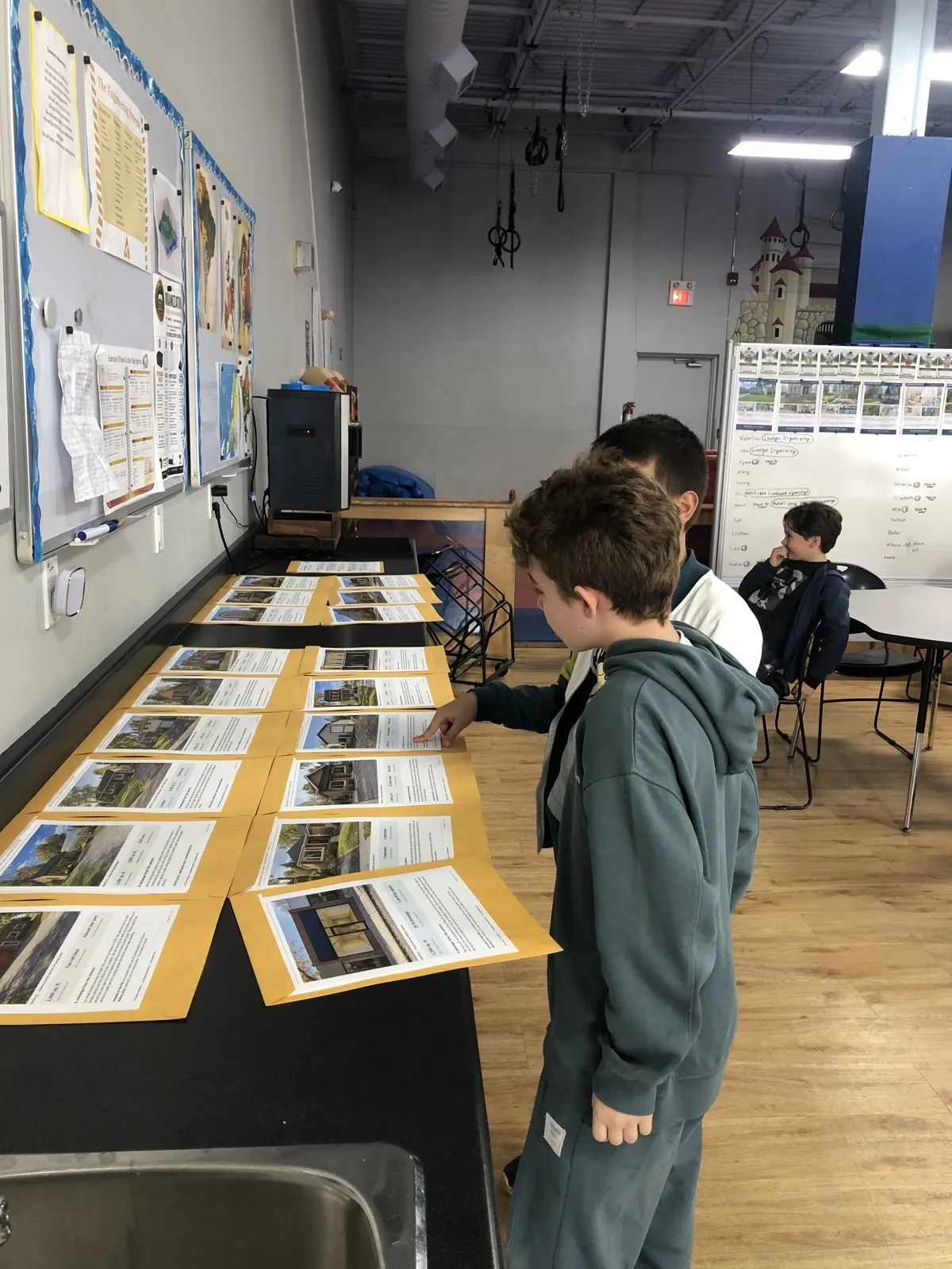 Evergreen students comparing printed research during a collaborative classroom inquiry