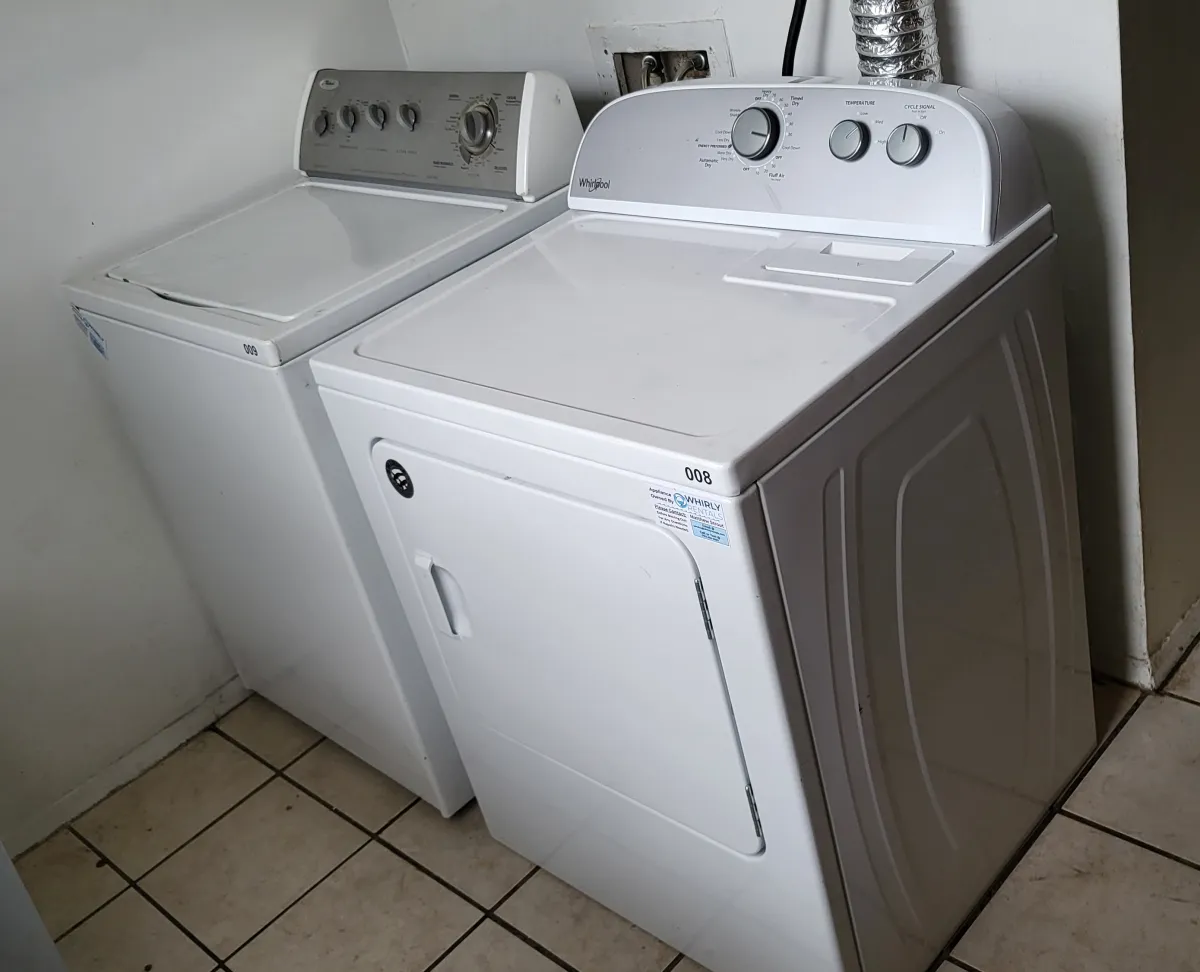 a bunch of white shirts hanging on a rack