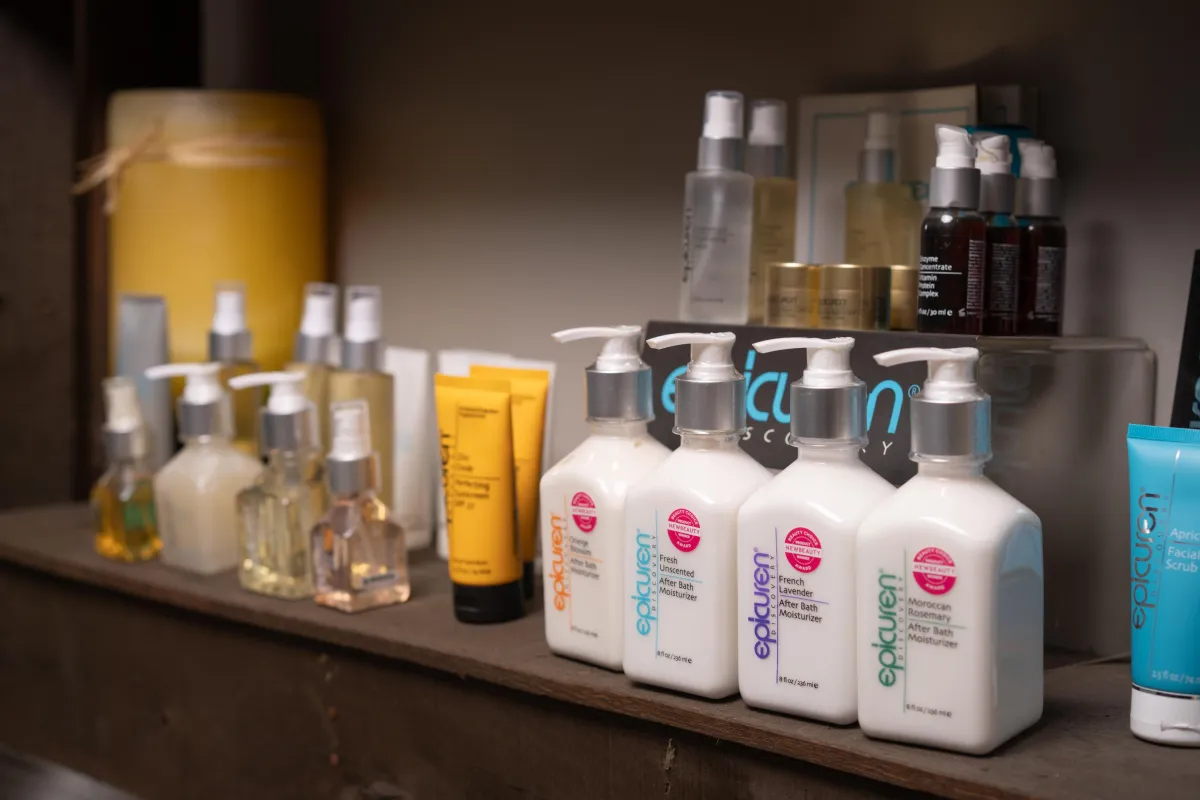 A close-up of a luxurious spa bath with floating rose petals, soft towels, and a golden tray, highlighting opulence and attention to detail.