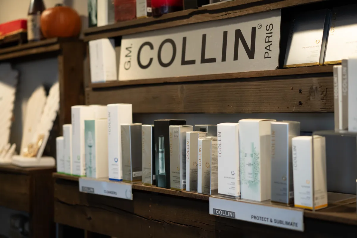 A modern spa waiting area with lush indoor plants, minimalist decor, and natural sunlight streaming through large windows, evoking freshness and comfort.