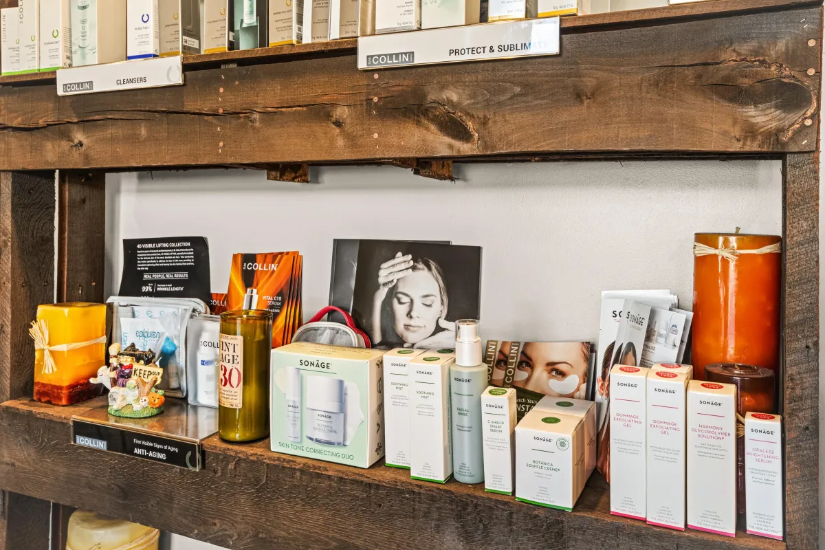 A tranquil spa treatment room with a massage table, soft white linens, and gentle candlelight, creating a peaceful and inviting atmosphere for relaxation.