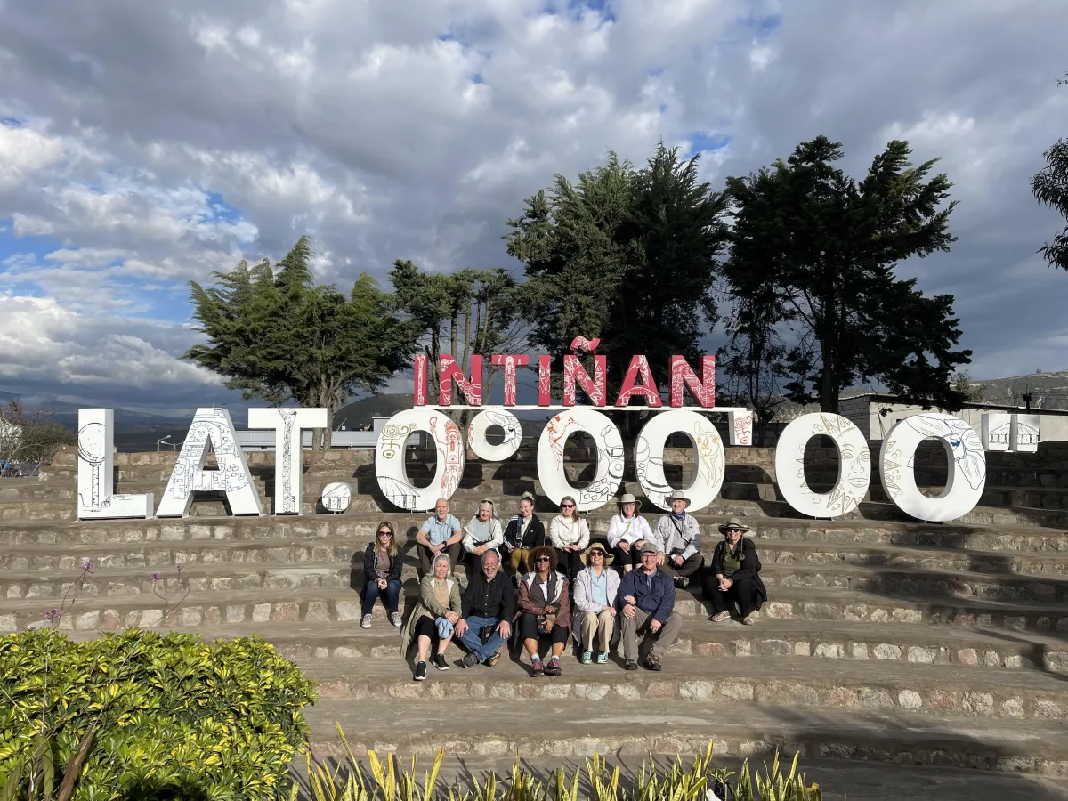 A group of women in red dresses standing next to each other