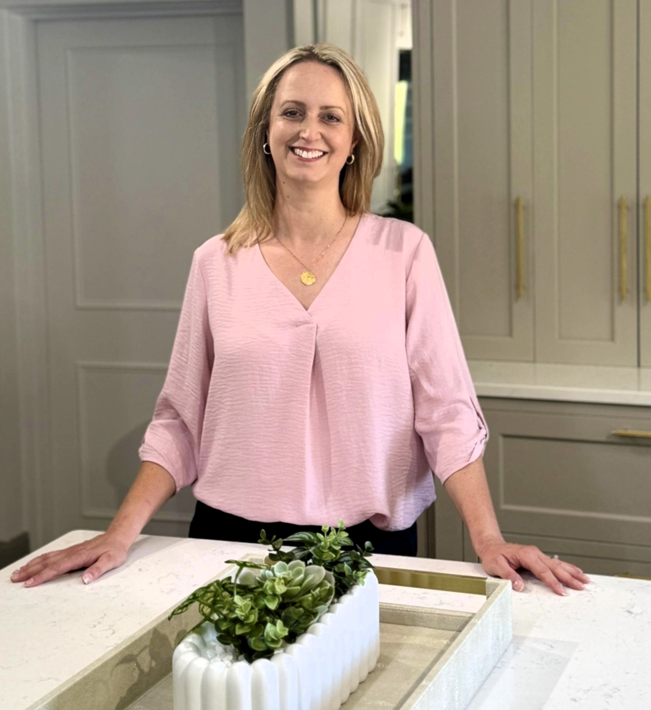 Picture of Becky Purchas, founder of White Space standing by a centre island unit in a kitchen
