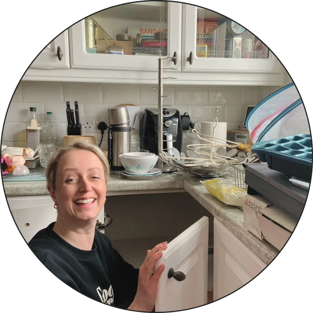 Picture of Becky from White Space decluttering a kitchen cupboard
