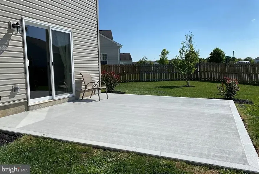 Freshly finished concrete patio attached to the back of a home in Bear, Delaware.