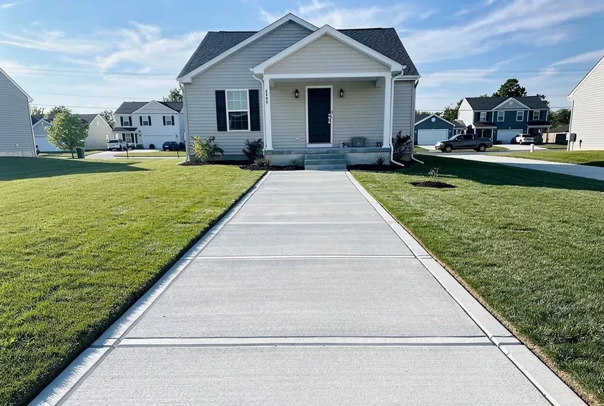 Freshly finished concrete sidewalk alongside a home in Bear, Delaware.