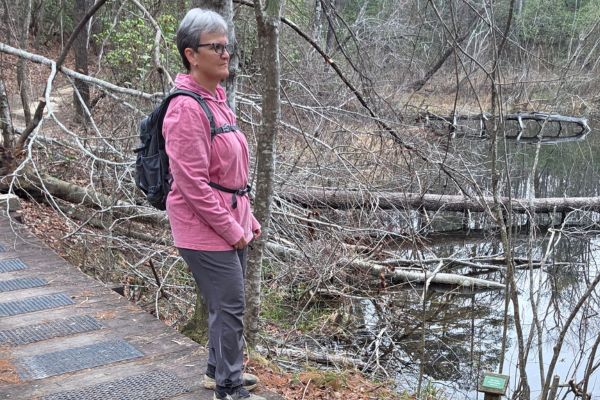 Claudette Eames hiking on a nature trail representing active living and the longevity advantage