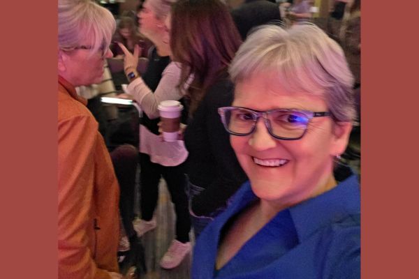 Claudette Eames networking at a business event, reflecting on how building a business shapes confidence, relationships, and personal growth.