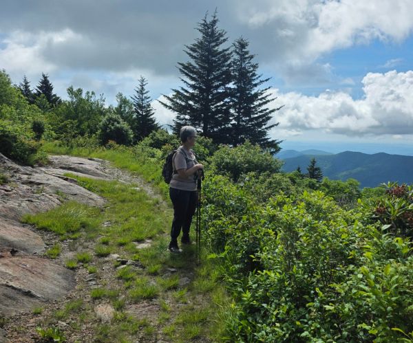 Woman overlooking the Blue Ridge Mountains, reflecting on finding peace, purpose, and a life she never expected to love after loss.