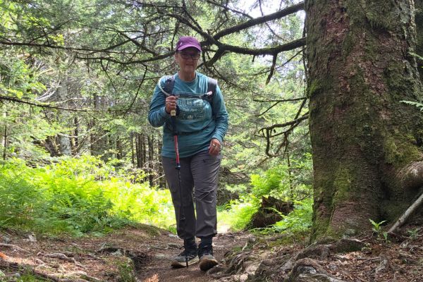 Claudette Eames hiking through a forest, reflecting on rebuilding health through intentional daily choices and consistent habits.